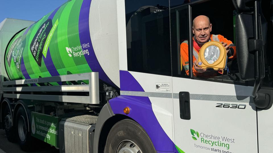 A CWR vehicle with a man holding a defibrillator out the window