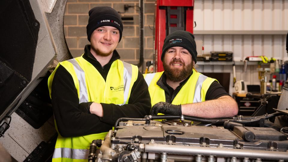 Jamie and Connor smiling in the workshop